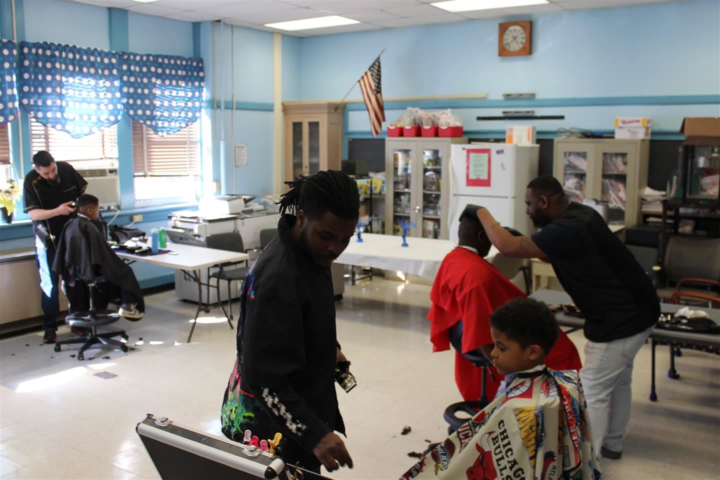  Three barbers from local barbershops cut hair at Clinton Elementary School on Wednesday, March 15, 